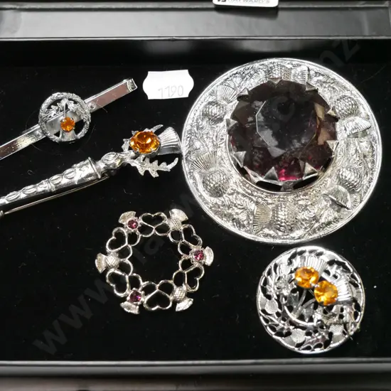 box of Scottish themed brooches