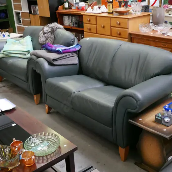 pair of green leather rolled arm 2 seater settees in very condition