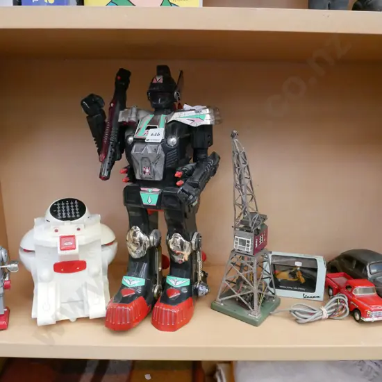 shelf; plastic robots, model train layout crane, model vehicles