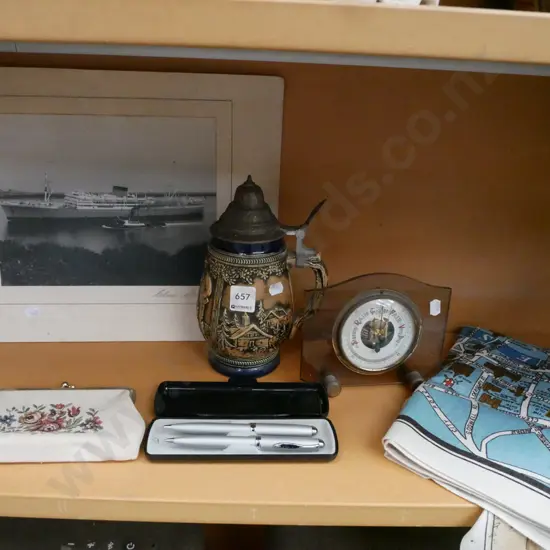 shelf; tea towels, pens, beer stein, ship photograph etc