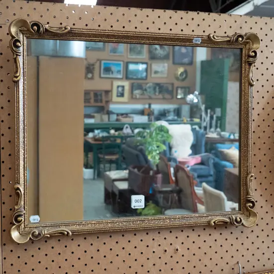 gilt-framed wall mirror