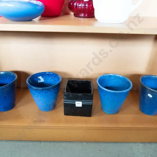 4 blue glazed and one black planter