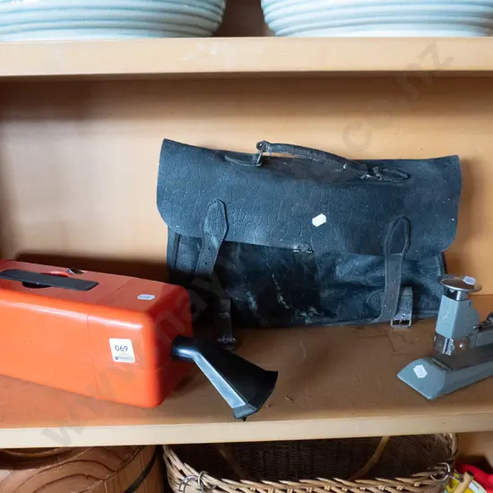 leather satchel, vintage stapler, early battery powered dust buster