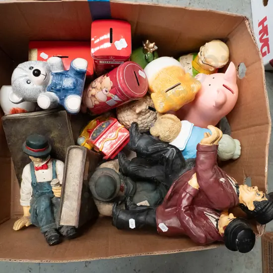 box of Laurel & Hardy figurines and book-ends, piggy banks, tins, etc