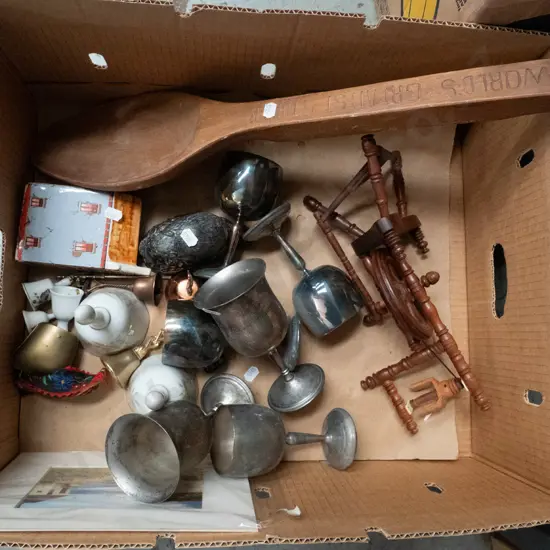 box of plated goblets, ceramic bells, wooden spoon, miniature spinning wheel, etc.