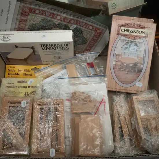 box of yet to be assembled doll's house furniture