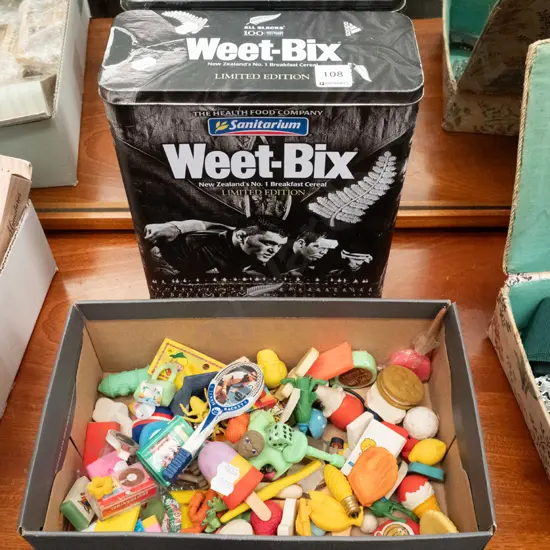 Weetbix All Blacks rugby tin and a box of 1980s erasers