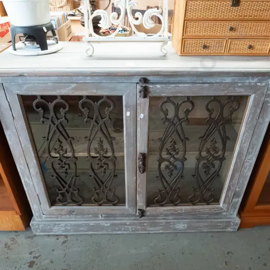 French themed glazed 2-door cupboard with distressed finish, wrought metal decoration H-910 W-1100 D-400