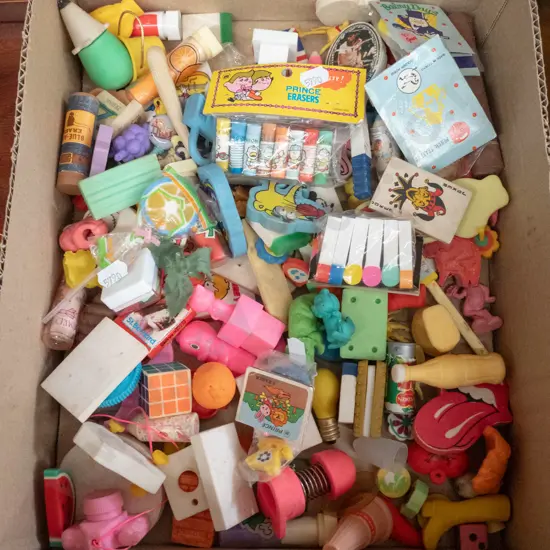 box of various 1980s erasers