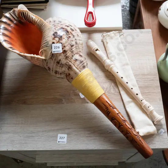 souvenir conch shell and a recorder