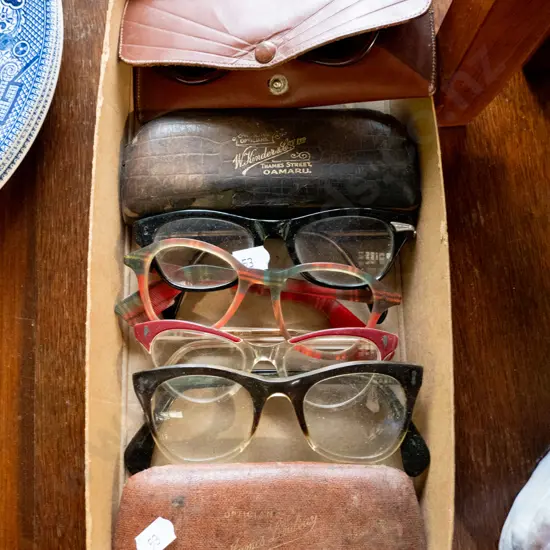 box of vintage reading glasses