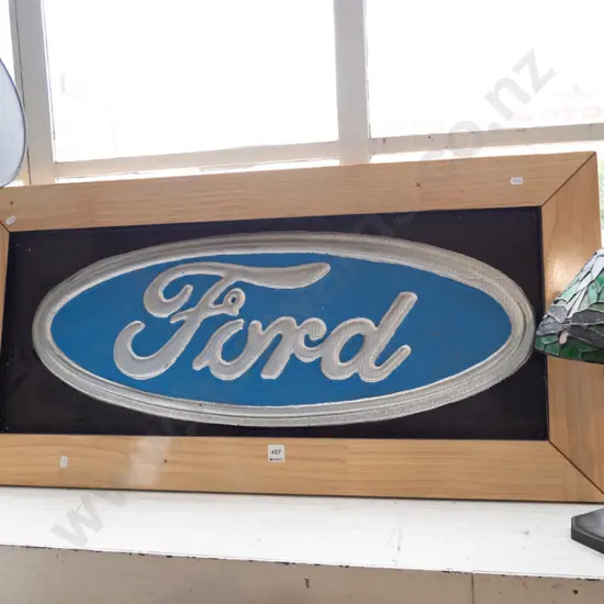 framed Ford motor sign in relief