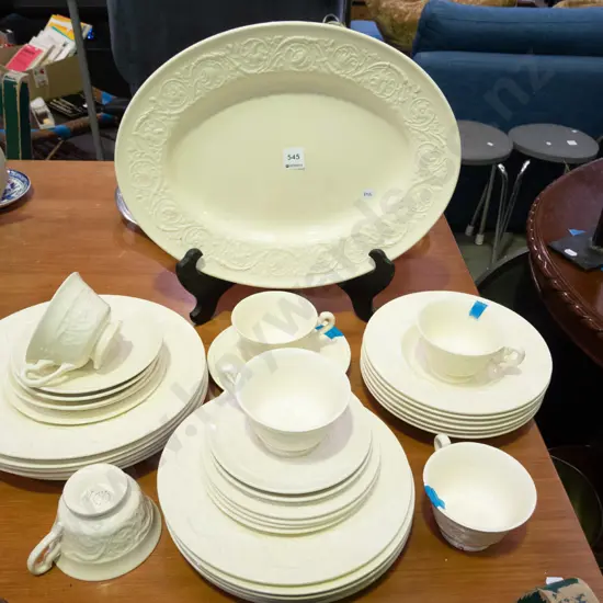 Wedgwood  cream dinner items with pattern relief; some chips to rims of cups