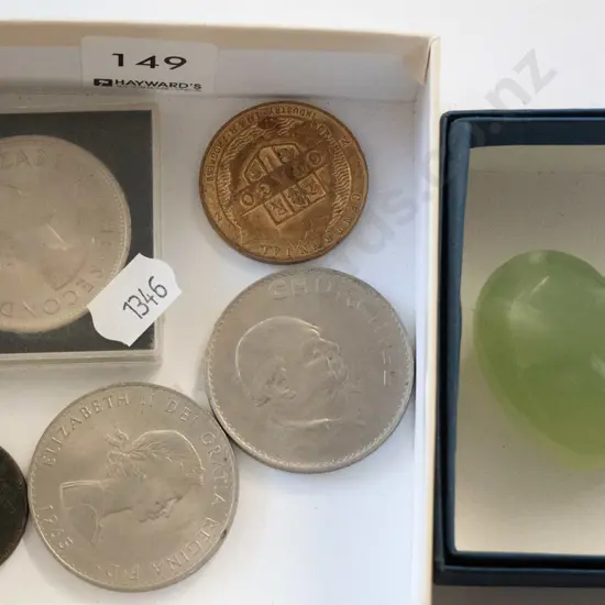 box of coins, polished heart shaped stone