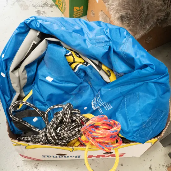 box; deflated ski biscuit and tow rope