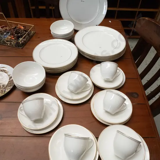 assorted white and gold rimmed dinner items; plates, bowls etc
