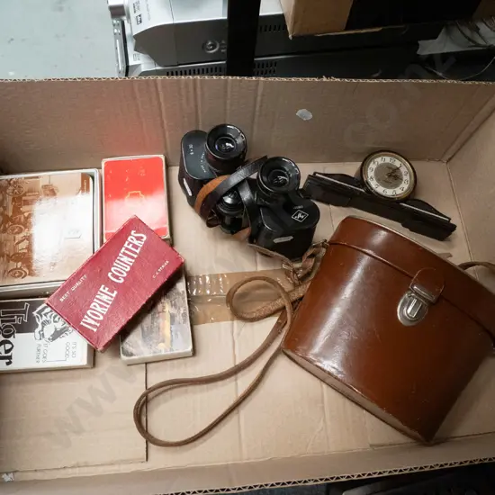box; leather cased 8x30 binoculars, playing cards, small mantle clock etc