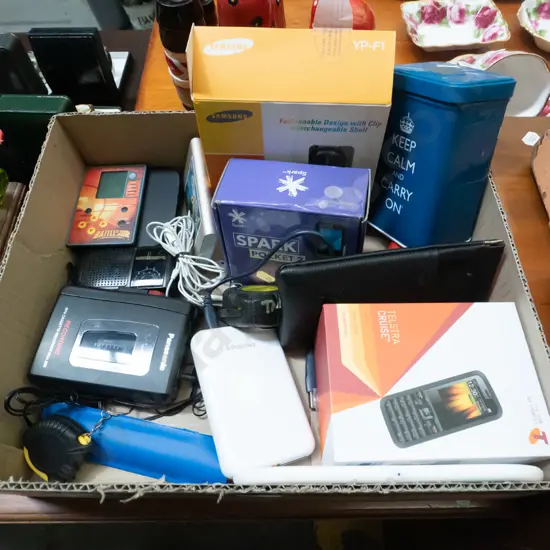 box; cell phones, Samsung music player, tape measures, cassette players etc