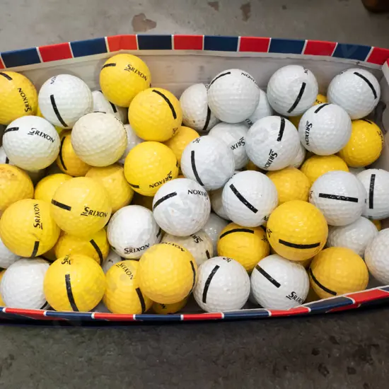 shoe box of driving range golf balls