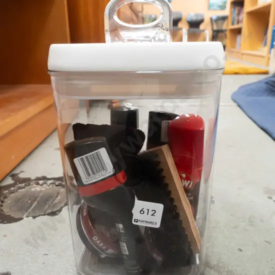 plastic storage container, shoe polish and brushes
