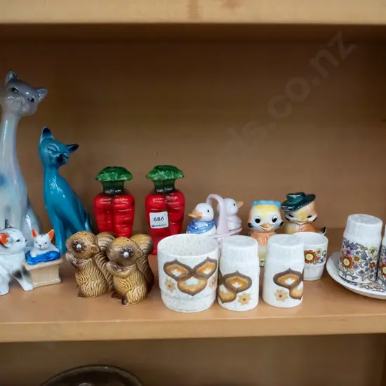 shelf of novelty salt and peppers, 2x cat figurines