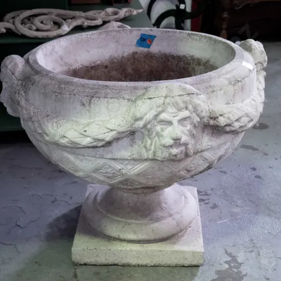 large cast concrete classical style garden urn w/ intertwined swags and female heads, pedestal base on square foot -