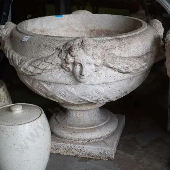 large cast concrete classical style garden urn w/ intertwined swags and female heads, pedestal base on square foot