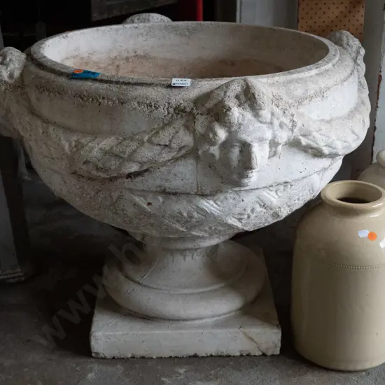 large cast concrete classical style garden urn w/ intertwined swags and female heads, pedestal base on square foot - has