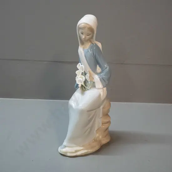 Lladro figure of a sitting girl with arum lilies H-240