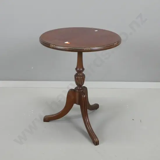 mahogany round wine table on pedestal base w/ fluted sweeping legs, staining to top surface H-520 D-400