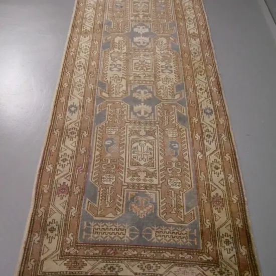 hand-knotted Persian style wool floor rug - light browns and blue, reds have faded away, has staining L-2950 W-1100