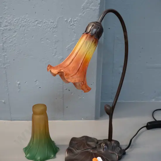 reproduction lily pad table lamp with metal stem, composite base and frosted glass trumpet flower shade and a spare
