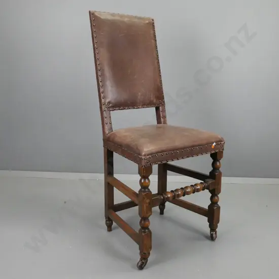 19th century Tudor style leather covered high-back chair w/ turned stretcher base on porcelain casters H-1140 W-510