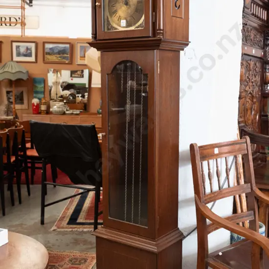 reproduction German long cased clock with glazed top door, metal face w/ Tempus Fugit, cross-banded panel w/oval shell