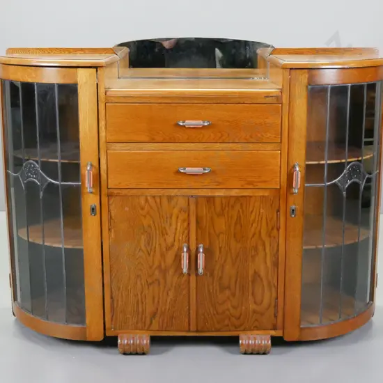 art deco oak double ended display case with small mirrored back, 2 drawers, quarter round ends with curved leadlight