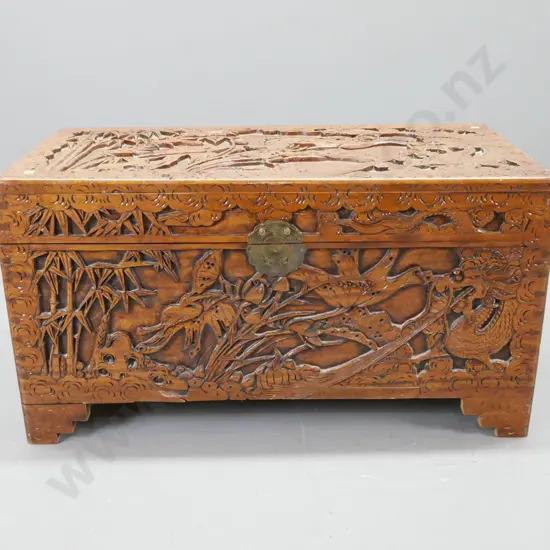 profusely carved camphorwood chest with heron and bamboo motifs, brass lock plate, damaged lock pieces inside