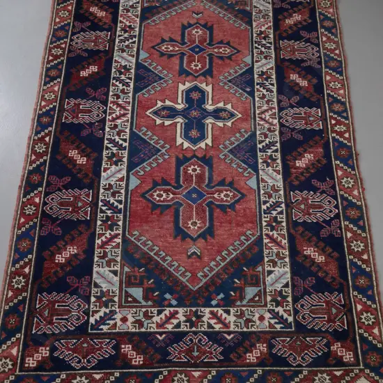 Persian style hand-knotted wool floor rug - reds, blue, brown and cream - overall slight fading L-2000 W-1240