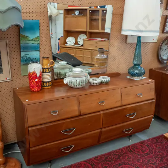 retro mahogany low 7-drawer dresser with shaped mirror, metal diamond shaped handles, round splayed feet, has Zealandia