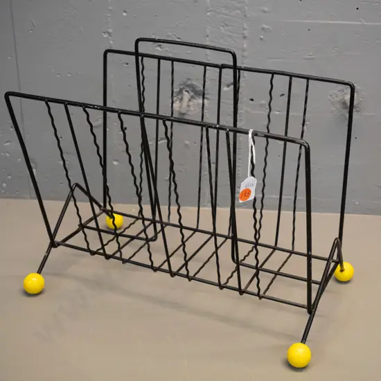 mid-century metal magazine rack with yellow ball feet - some flaking to black paint H-350 L-370 W-230