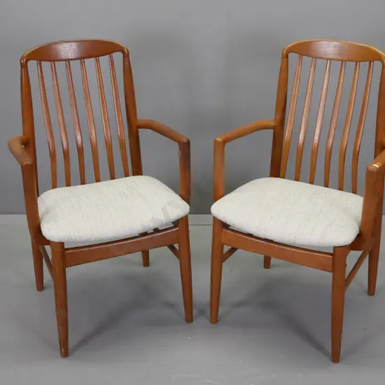 pair of mid-century teak rib-back armchairs with fabric upholstered seats, on round tapered legs - minor wear to arms
