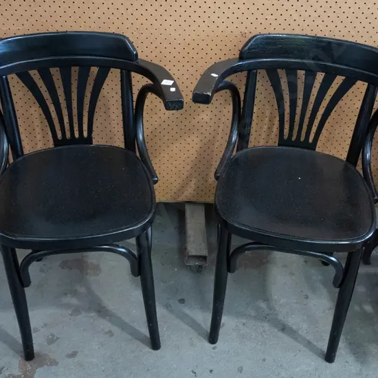 2 black painted wooden armchairs
