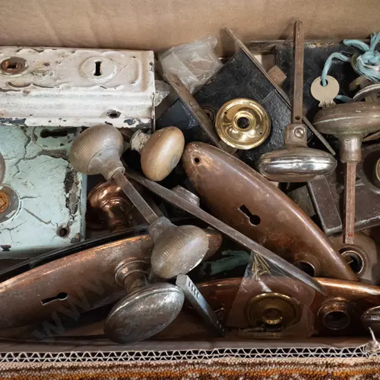 box of vintage door hardware