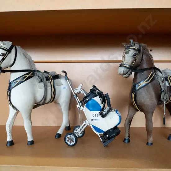 2 horse figurines and a miniature golf trundler