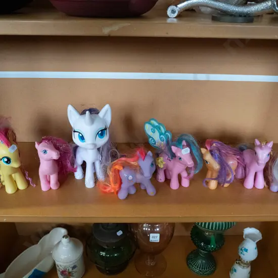 shelf of My Little Pony figures