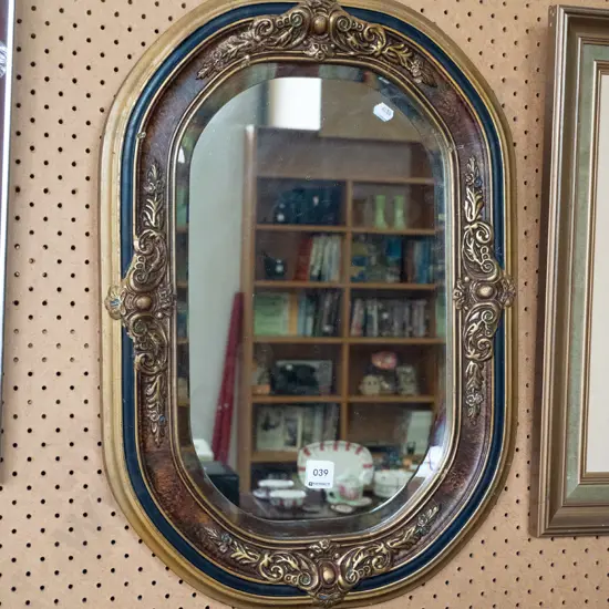 oval framed bevelled edge wall mirror