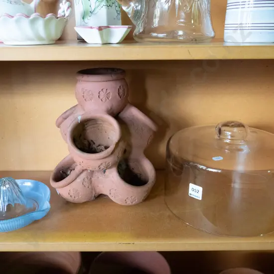 small terracotta strawberry planter, glass cover jar, lemon squeezer