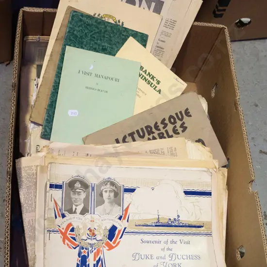box of old newspapers, royal visit publications, local guides, etc.