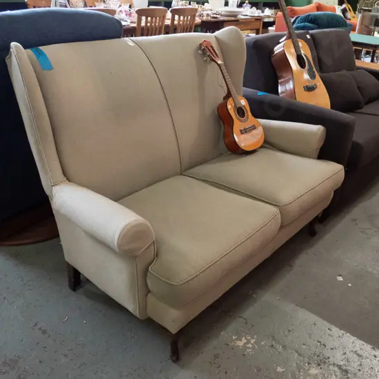cab-leg upholstered wing-back 2-seater settee