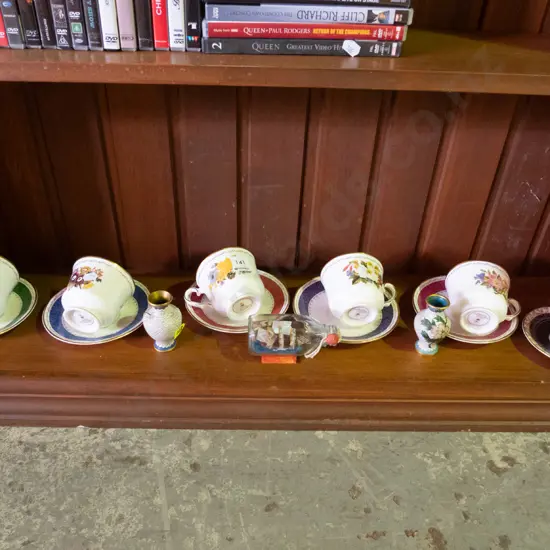 shelf of cups, saucers, 2 cloisonne vases and ship in a bottle