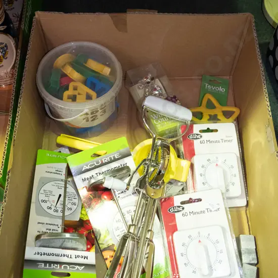 box of kitchen allsorts, meat thermometers, timers, cookie cutters etc.